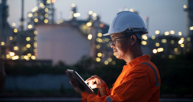 Worker holding an explosion proof tablet on a hazardous mine site 