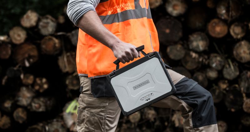 Australian worker holding rugged laptop 