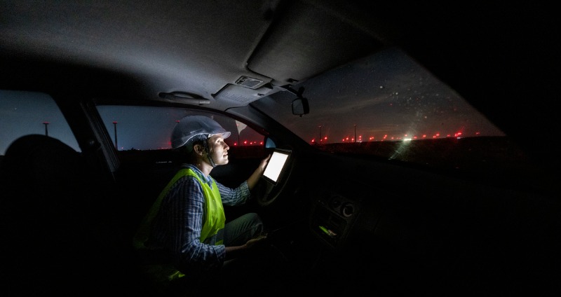 Engineer working in the field while browsing to find the best rugged tablet to suit her needs and job.