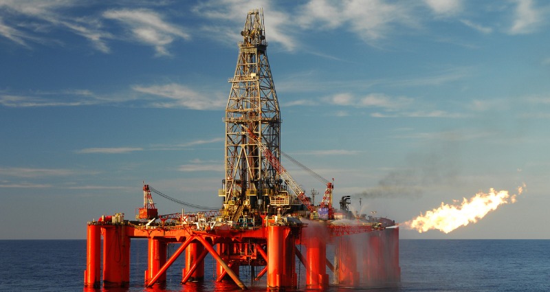 An oil rig in Australia flaring natural gases with workers using intrinsically safe devices