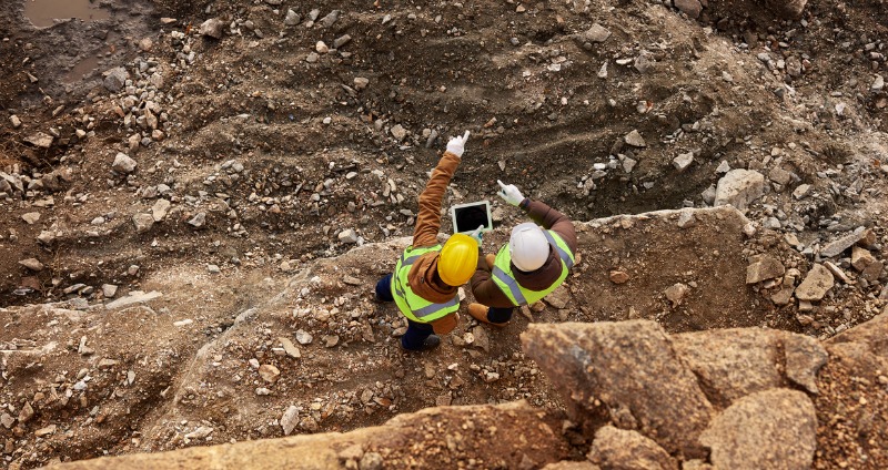 Two miners working on an Australian mine using a rugged handheld device 