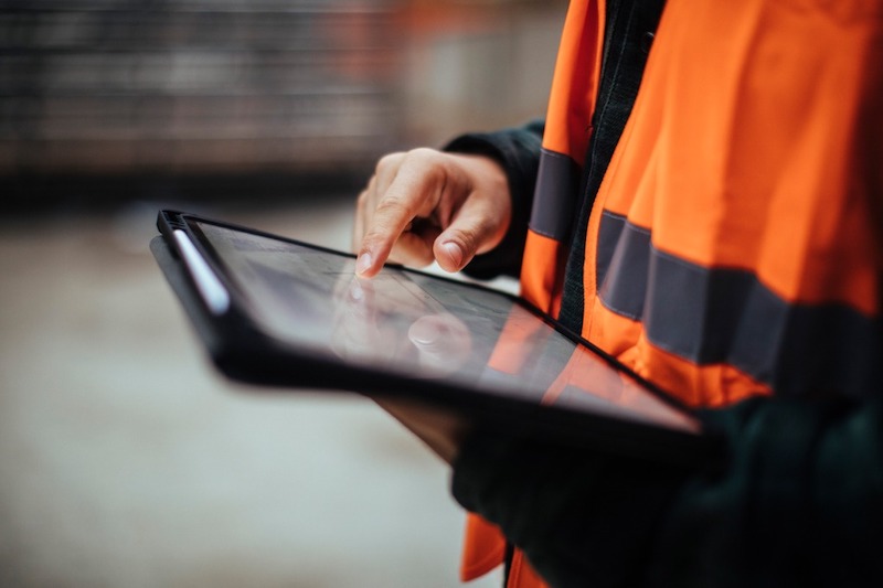 Construction worker using a tablet on-site